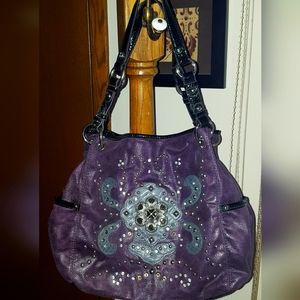 Purple Kathy Van Zeeland studded, jeweled handbag.